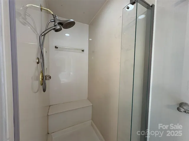 a bathroom with a glass shower door
