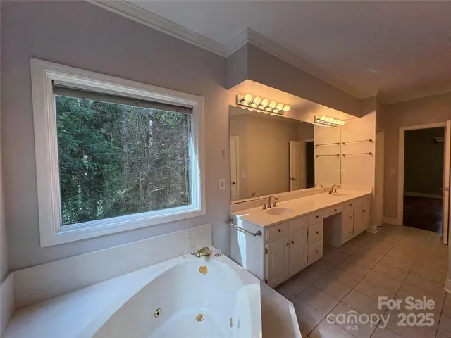 a large bathroom with a large tub and sink