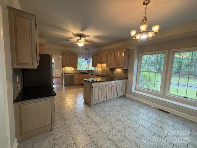 a kitchen with stainless steel appliances granite countertop a stove and a sink
