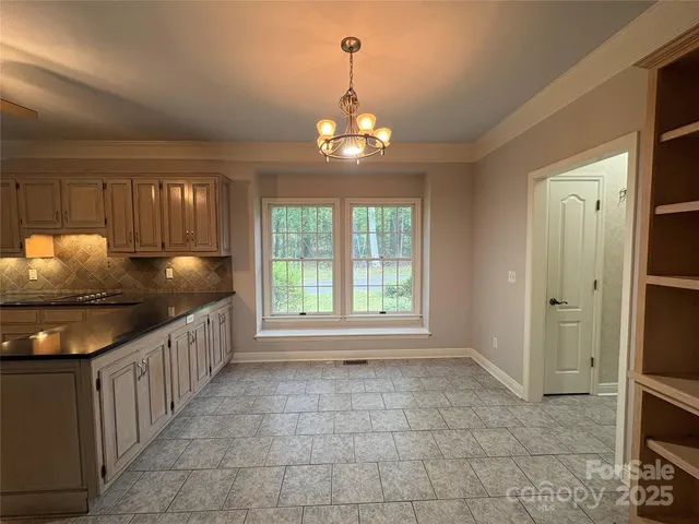 a kitchen with granite countertop a stove and a sink
