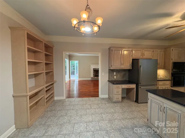 a kitchen with a refrigerator and a stove top oven