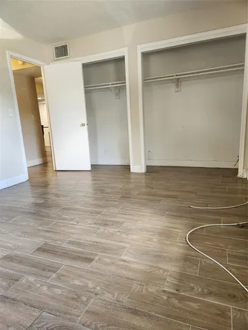 a view of a room with wooden floor and closet