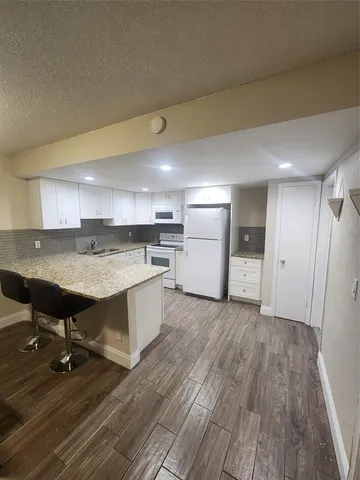 a view of kitchen and wooden floor