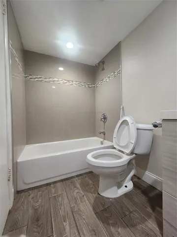 a bathroom with a toilet a sink and bathtub