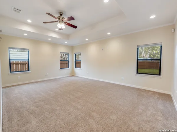 a view of an empty room with a ceiling fan