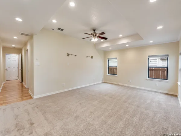an empty room with fan and windows