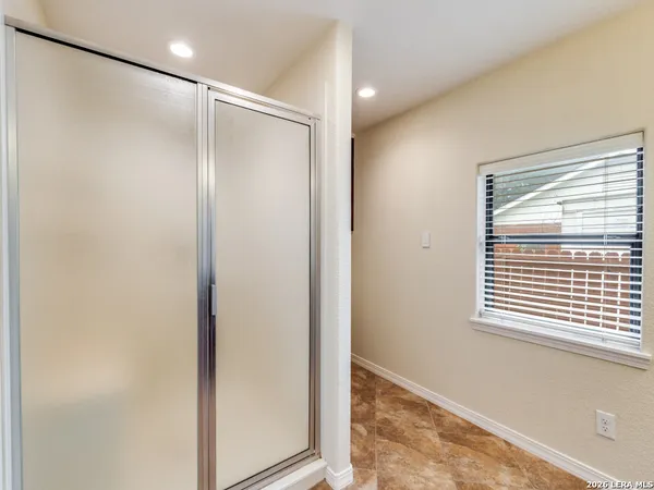 a bathroom with a shower and a window