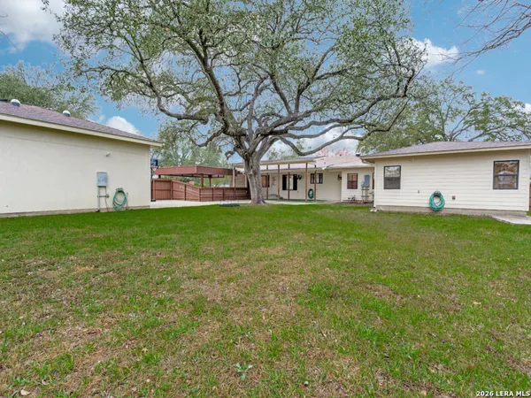 front view of a house with a yard and a trees