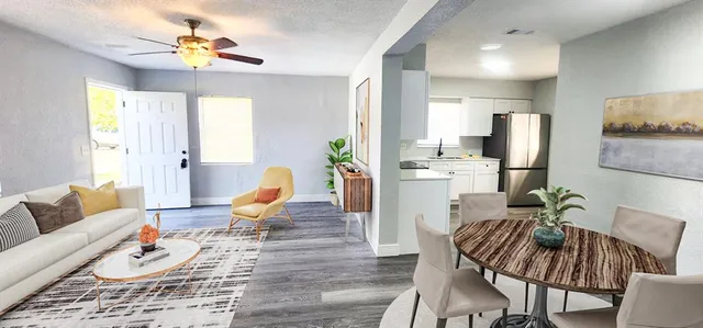 a living room with furniture fireplace and a chandelier
