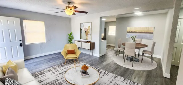 a living room with furniture and wooden floor