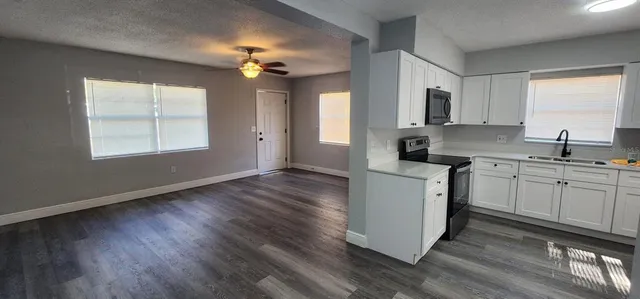 a kitchen with a sink cabinets and window