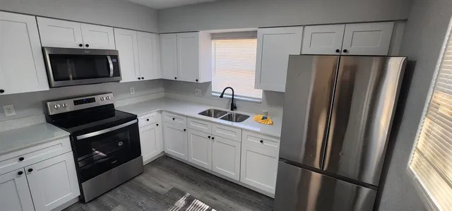 a kitchen with a refrigerator sink and microwave