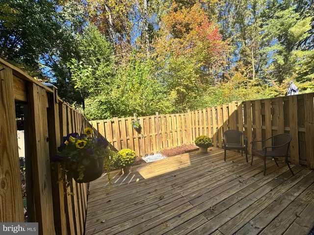 a view of balcony with wooden floor and seating space