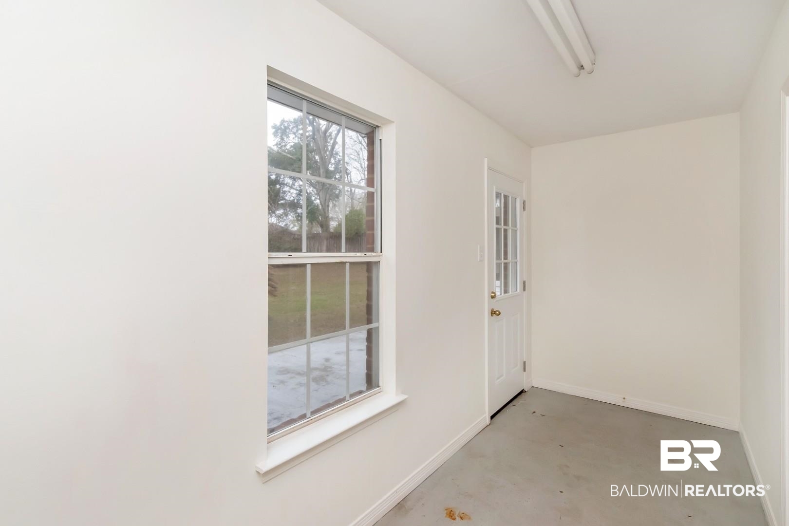 10006 Wedgefield Court Mobile, AL 36608 - Photo 29 of 34 Interior space featuring concrete flooring and baseboards