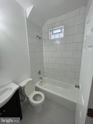 a bathroom with a sink a toilet and bathtub