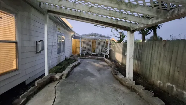 a view of a porch with furniture and a yard