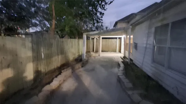 a view of a pathway of a house with a yard