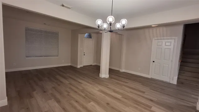 a view of a chandelier in a room with wooden floor