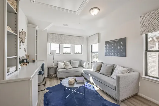 a living room with furniture and kitchen view