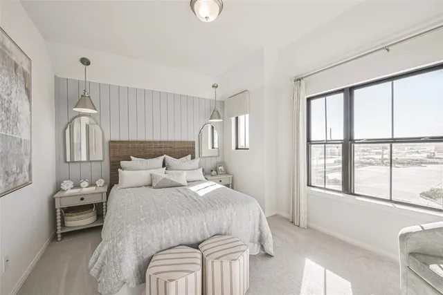 a spacious bedroom with a bed and a couch