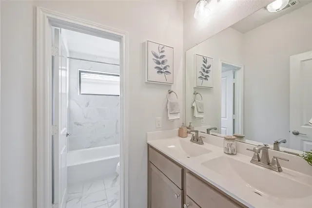 a bathroom with a bathtub a toilet and a shower