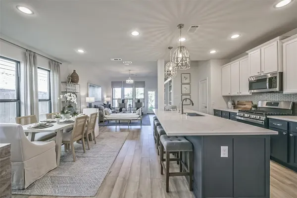 a large kitchen with stainless steel appliances lots of counter space and breakfast area