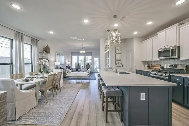 a large kitchen with stainless steel appliances lots of counter space and breakfast area