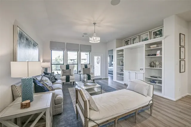 a living room with furniture and a chandelier