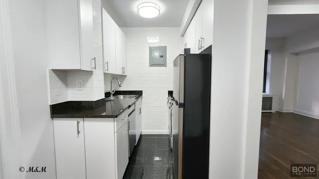 a kitchen with a refrigerator and a stove
