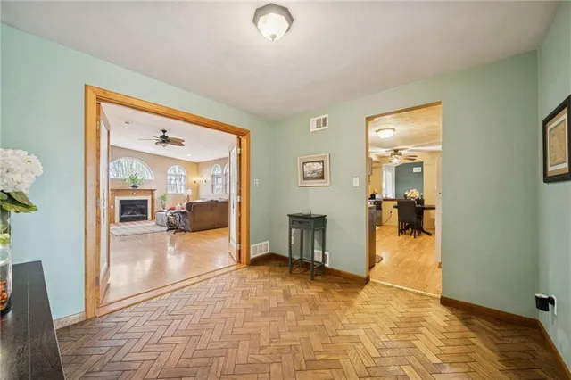 a view of a hallway view with living space and dining room view