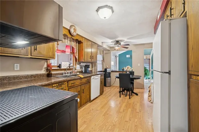 a kitchen with a sink a counter top space and stainless steel appliances