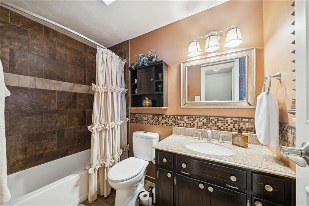 603 Forbes Trail Road Greensburg, PA 15601 - Photo 32 of 38 a bathroom with a granite countertop sink toilet and shower