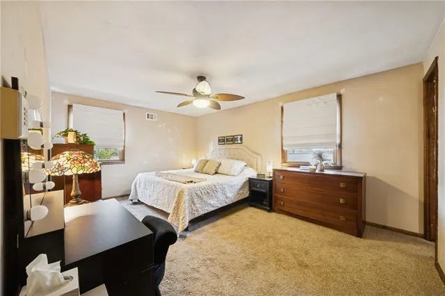 a bedroom with a bed window and couch