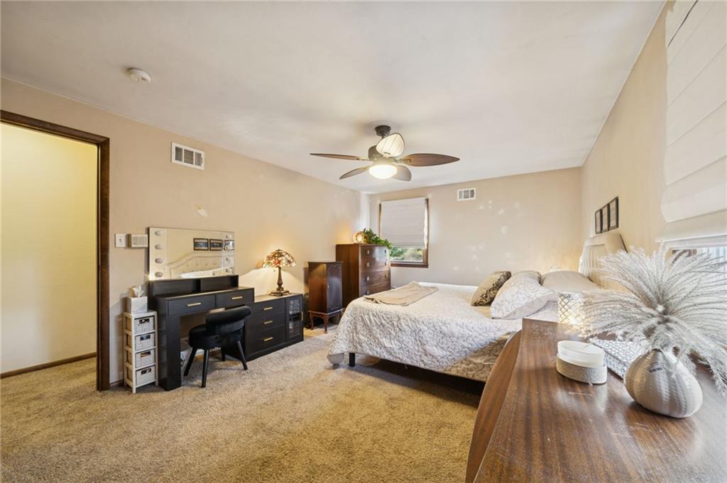 603 Forbes Trail Road Greensburg, PA 15601 - Photo 35 of 38 a bedroom with a bed and a chandelier