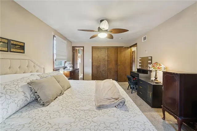 a bedroom with a large bed and dresser