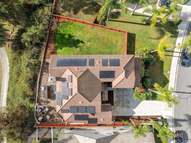 an aerial view of residential houses with outdoor space and street view