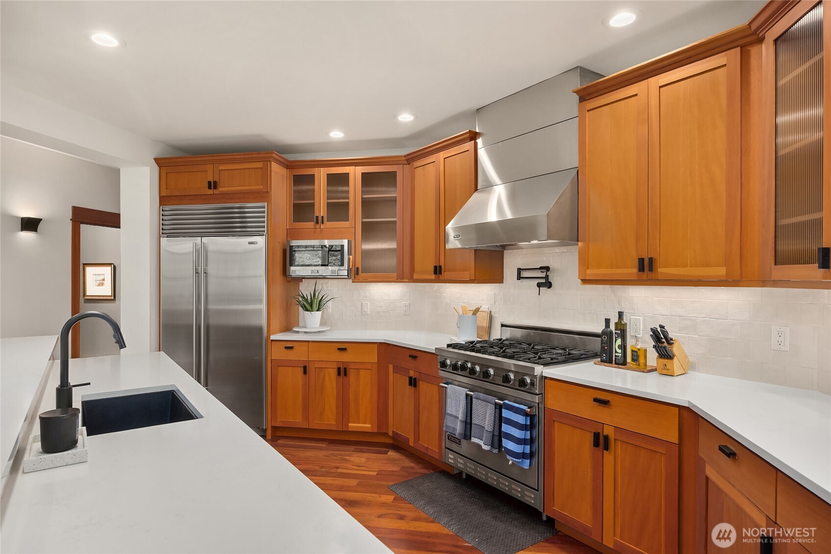 6477 Haley Loop Road Northeast Bainbridge Island, WA 98110 - Photo 11 of 40 a kitchen with stainless steel appliances granite countertop a sink stove and refrigerator