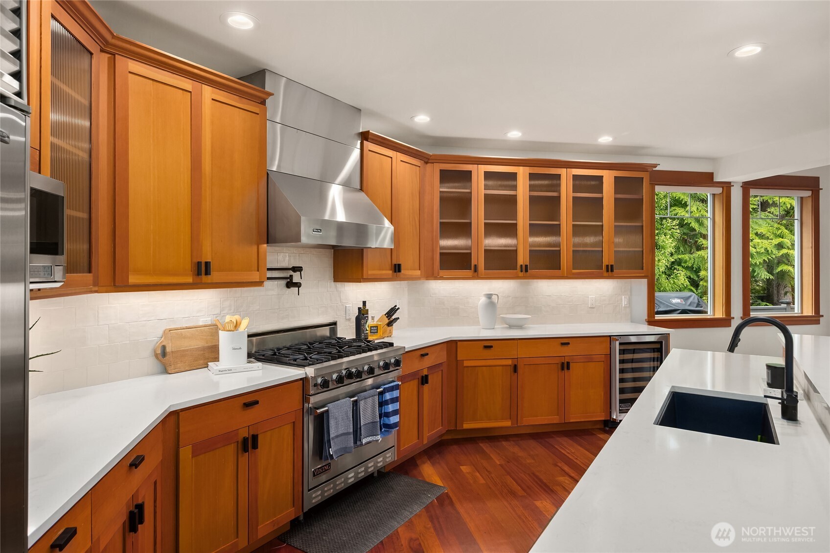 6477 Haley Loop Road Northeast Bainbridge Island, WA 98110 - Photo 12 of 40 a kitchen with stainless steel appliances a sink a stove and a refrigerator