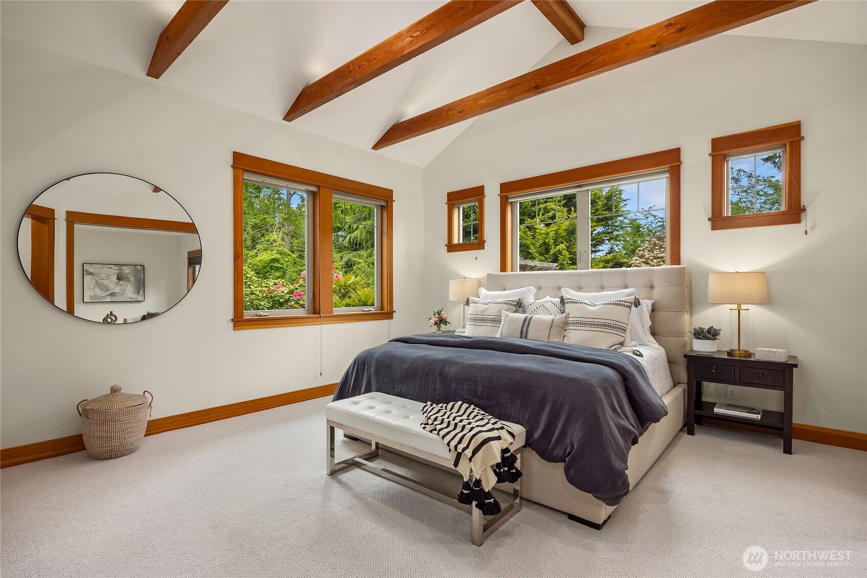 6477 Haley Loop Road Northeast Bainbridge Island, WA 98110 - Photo 19 of 40 a spacious bedroom with a bed a couch and large window