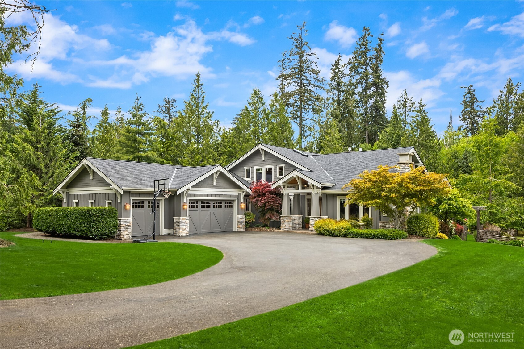 6477 Haley Loop Road Northeast Bainbridge Island, WA 98110 - Photo 2 of 40 a front view of a house with a yard