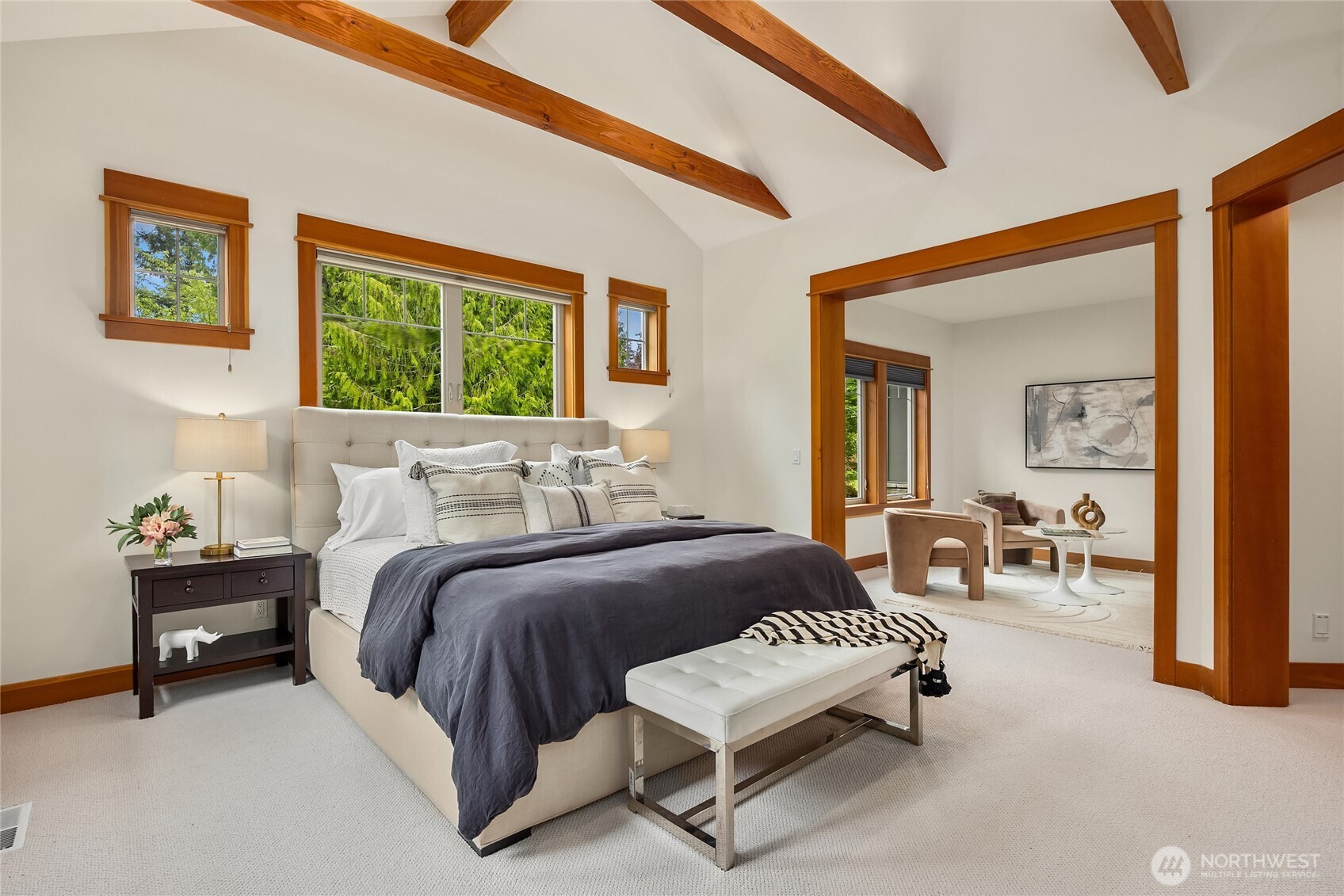 6477 Haley Loop Road Northeast Bainbridge Island, WA 98110 - Photo 21 of 40 a bedroom with a bed and a chandelier