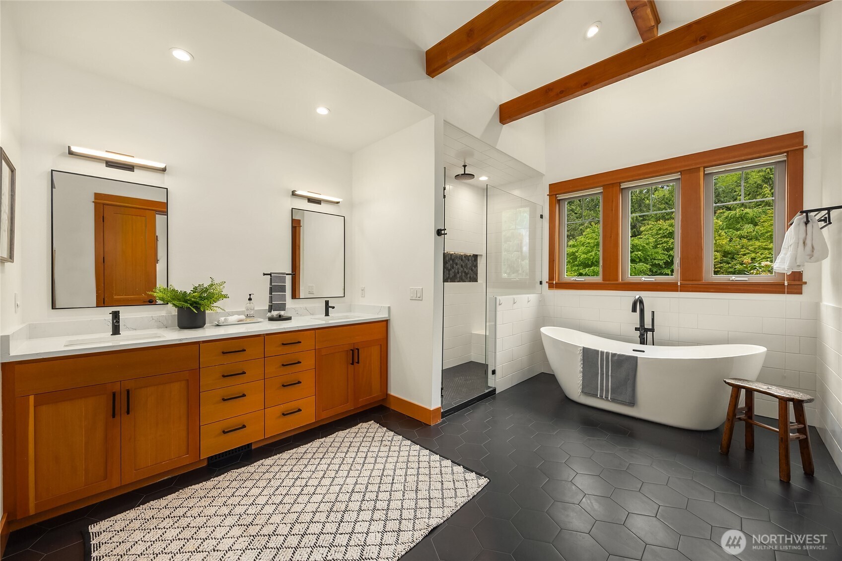 6477 Haley Loop Road Northeast Bainbridge Island, WA 98110 - Photo 23 of 40 a spacious bathroom with a double vanity sink a mirror and a bathtub