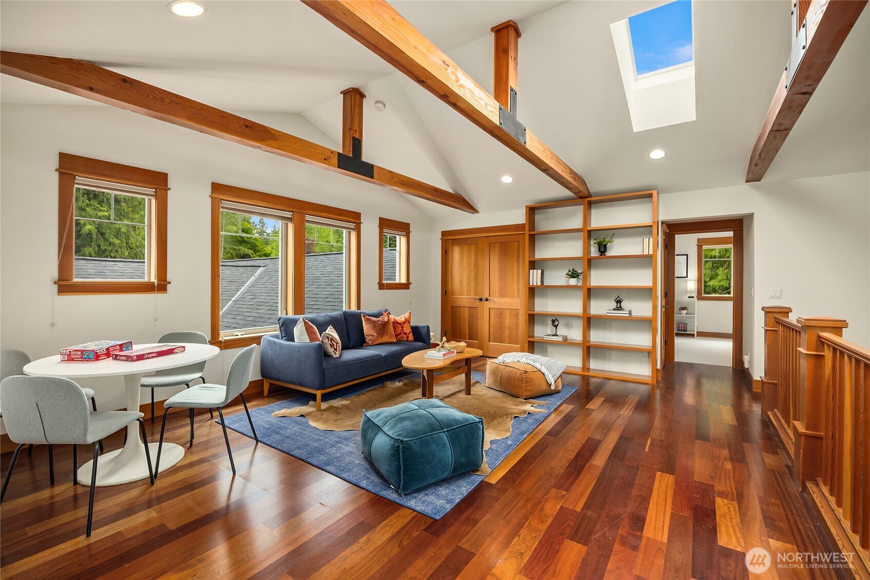 6477 Haley Loop Road Northeast Bainbridge Island, WA 98110 - Photo 26 of 40 a living room with furniture fireplace and wooden floor