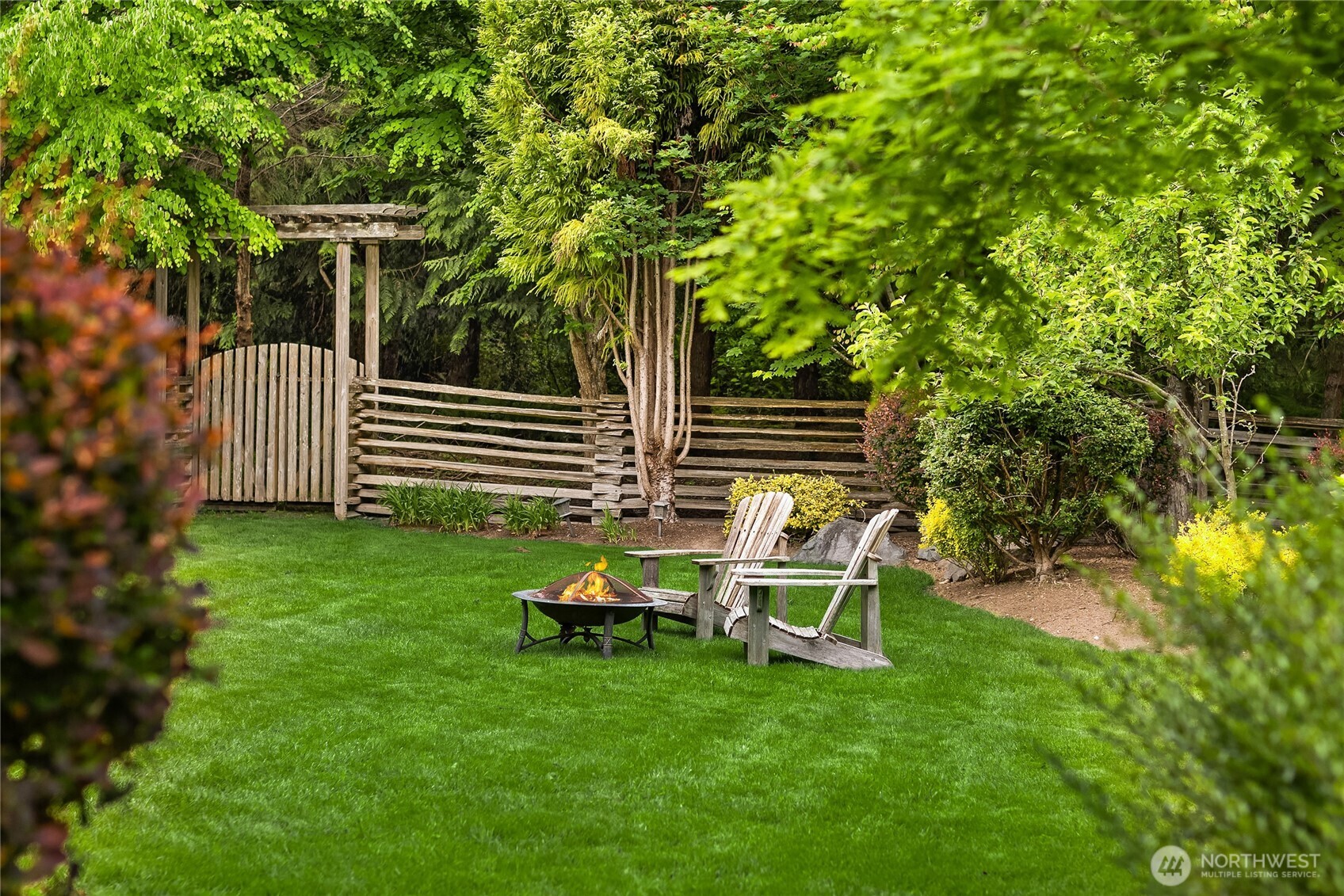 6477 Haley Loop Road Northeast Bainbridge Island, WA 98110 - Photo 32 of 40 a view of a chair and table in backyard of the house
