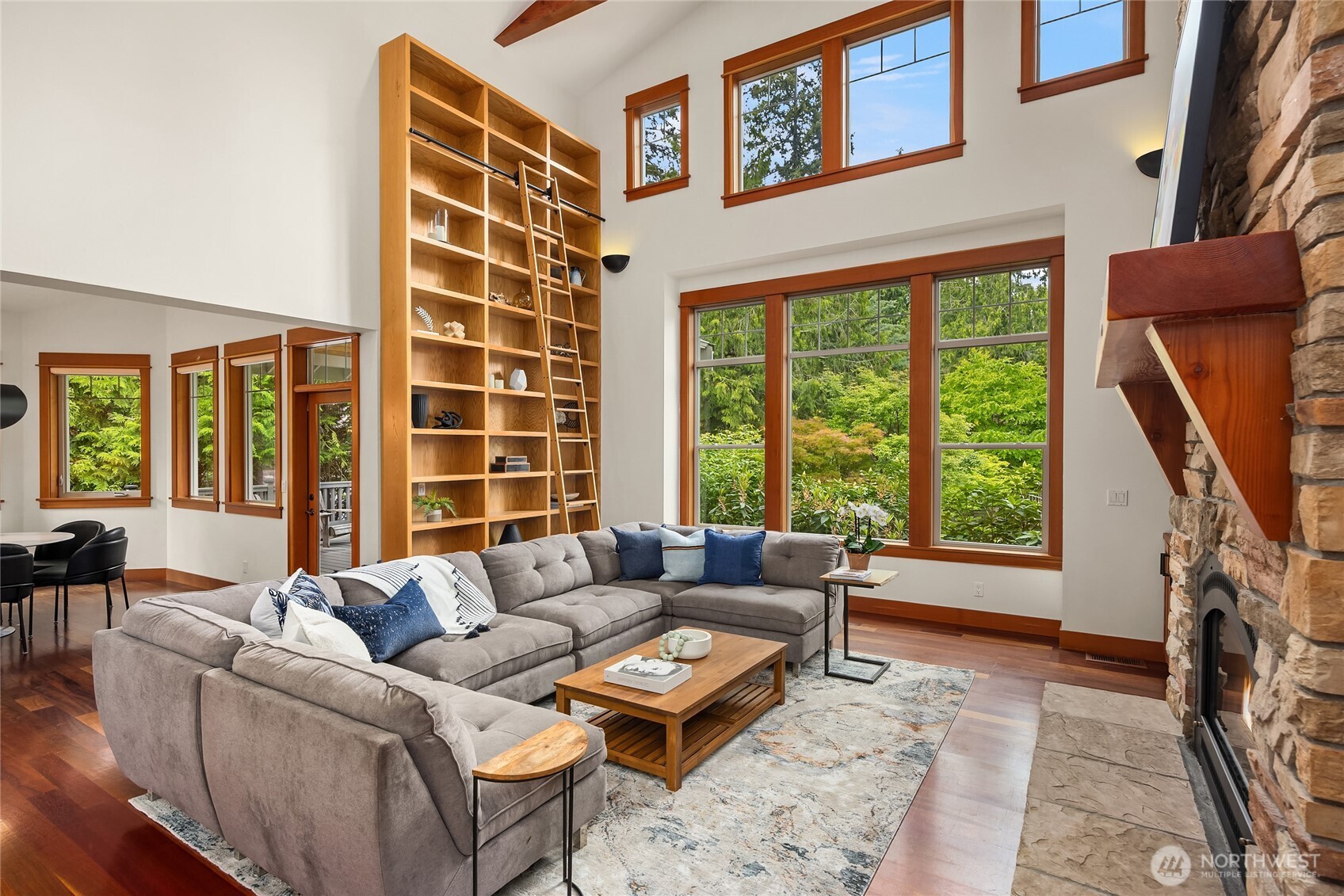 6477 Haley Loop Road Northeast Bainbridge Island, WA 98110 - Photo 6 of 40 a living room with furniture a flat screen tv and a window