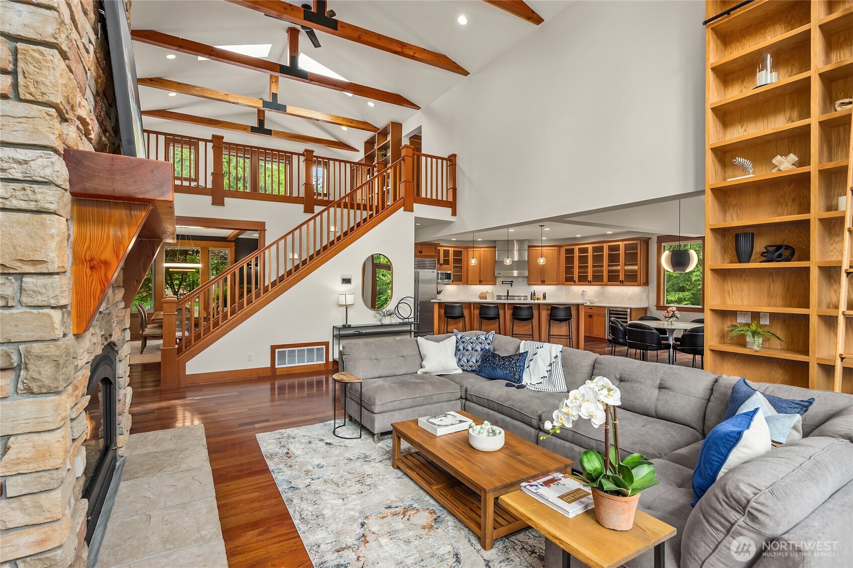 6477 Haley Loop Road Northeast Bainbridge Island, WA 98110 - Photo 8 of 40 a living room with furniture and a book shelf