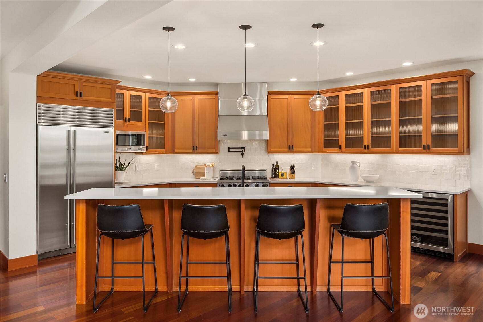 6477 Haley Loop Road Northeast Bainbridge Island, WA 98110 - Photo 10 of 40 a kitchen with stainless steel appliances granite countertop a table chairs sink and cabinets