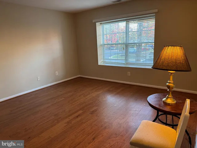 a room with wooden floor and a window