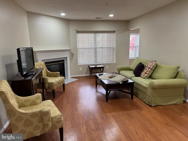 a living room with furniture fireplace and window