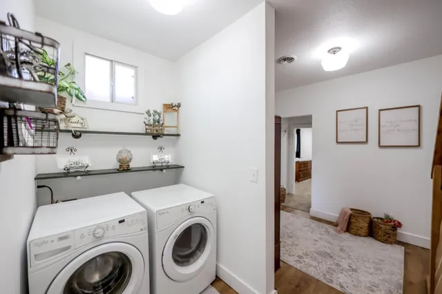 a view of washer and dryer with kitchen in the background